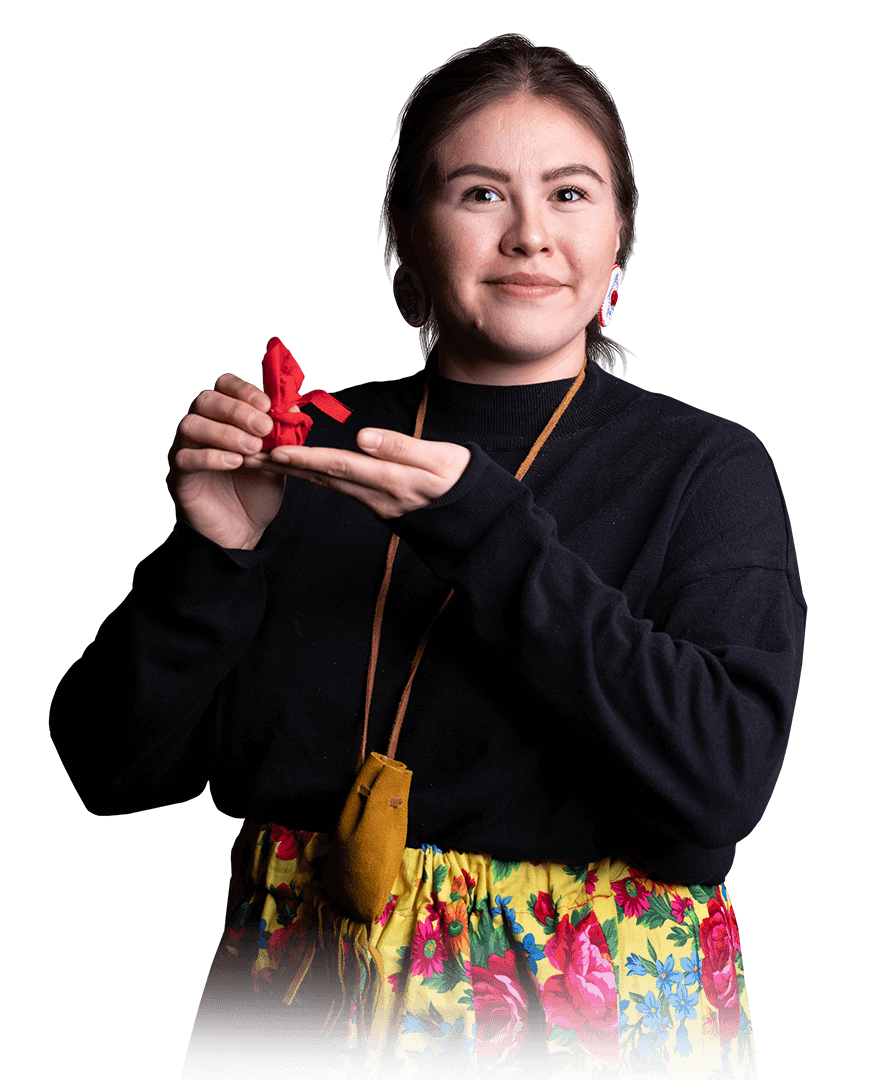 Photo of Tobacco Warrior Vanessa Kyme-Gilbert holding a small red pouch of Sacred Tobacco