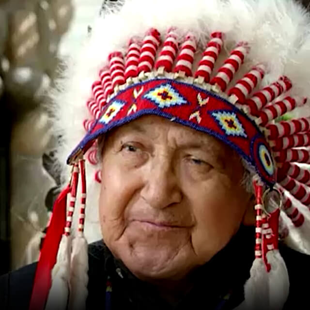 Close up Headshot of Elder Andre Bear Robe wearing traditional headdress